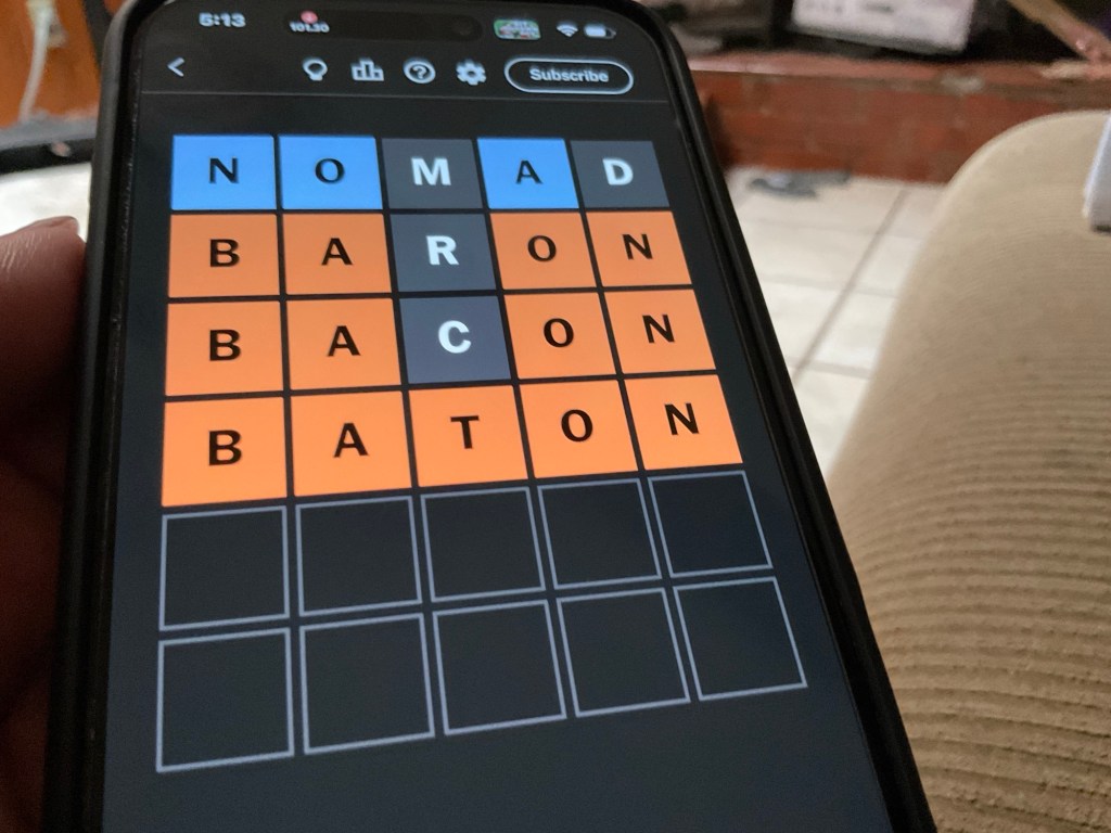 Photo is of a phone screen, opened to today’s Wordle game.